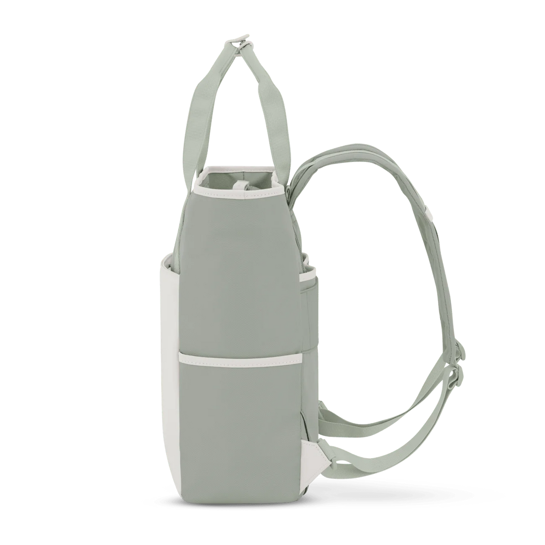Rear view in tote mode with tucked straps — muted sage