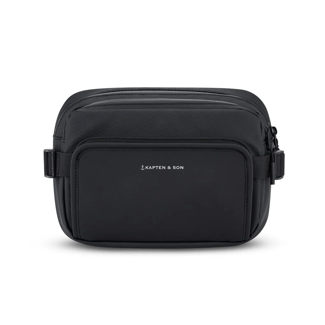 Kapten & Son Lisbon crossbody bag in black — front view with zip pocket and adjustable strap
