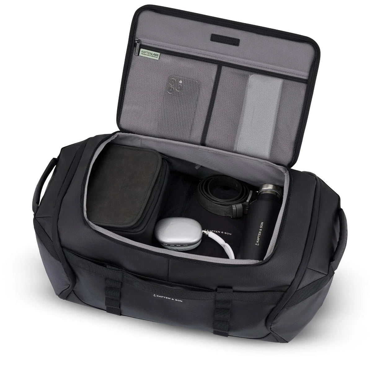 Black Lisbon Duffle Backpack Large opened and packed with a camera, a bottle and travel gear