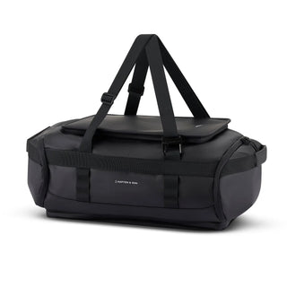 Kapten & Son Lisbon Duffle Backpack Small 33L in black — side view with grab handles