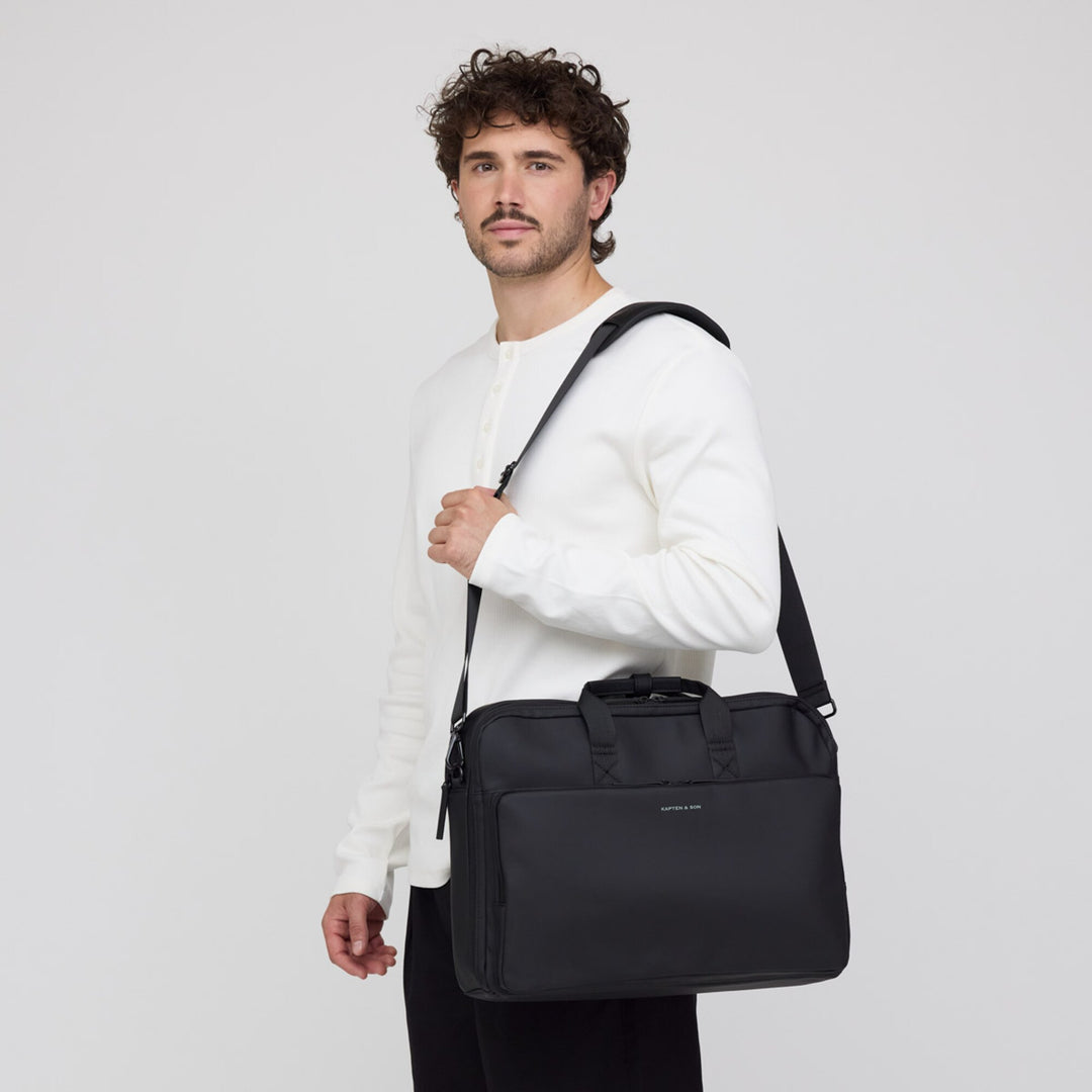 Man carrying the Bodo Laptop Bag on its shoulder strap