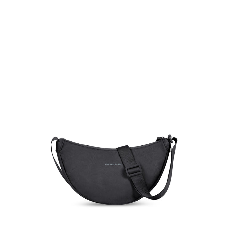 Black Essential Moon Bag with the strap shortened, adjuster buckle visible