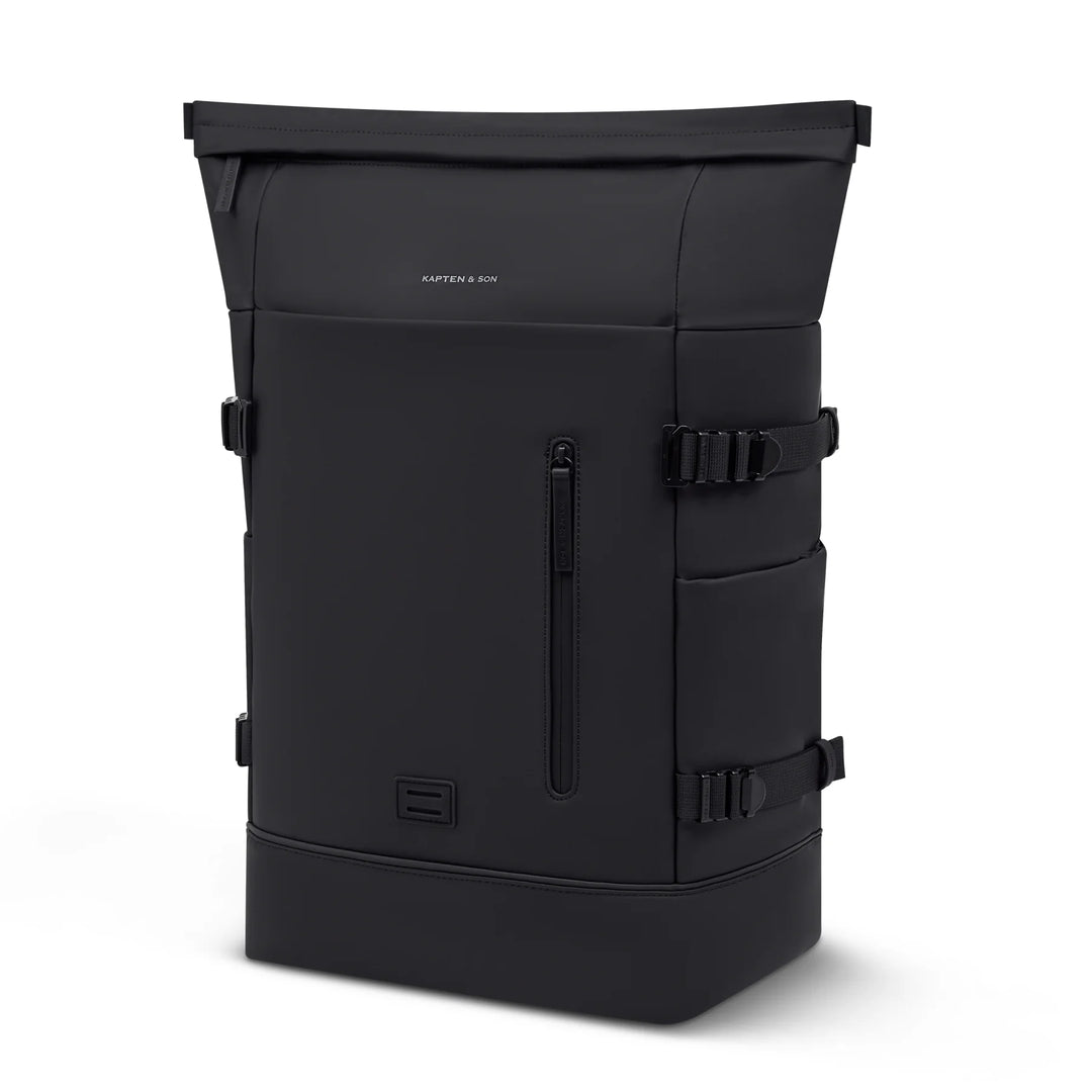 Kapten & Son Helsinki Pro Bike Backpack in black — three-quarter studio view with rolltop and pannier mounts