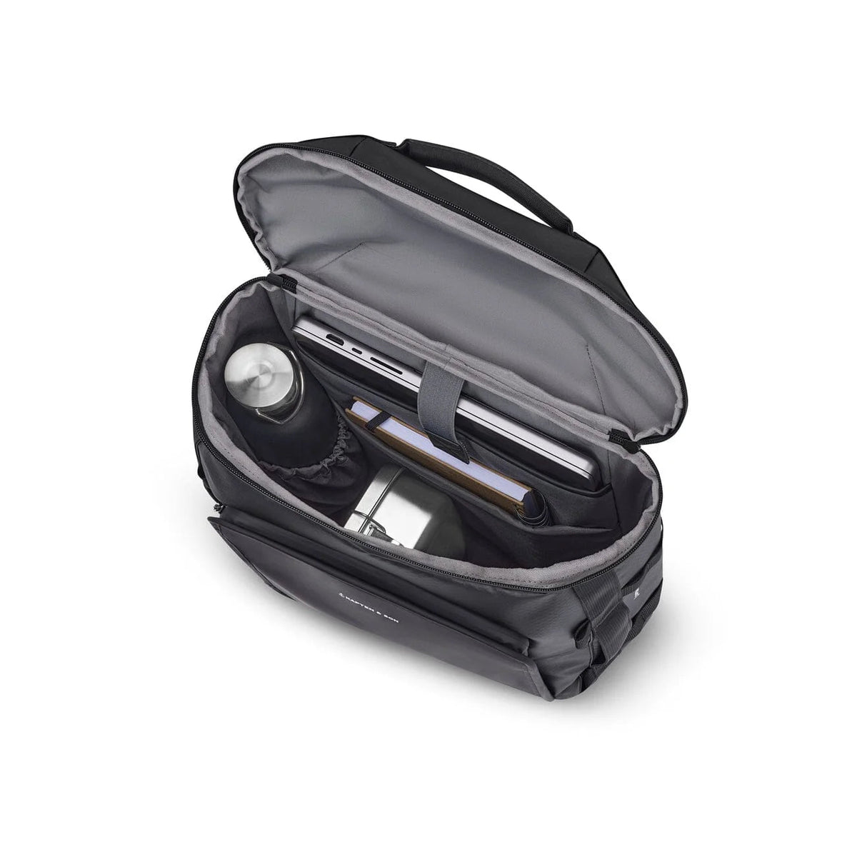 Black Lisbon Duffle Backpack Small packed with a laptop, a bottle and daily essentials