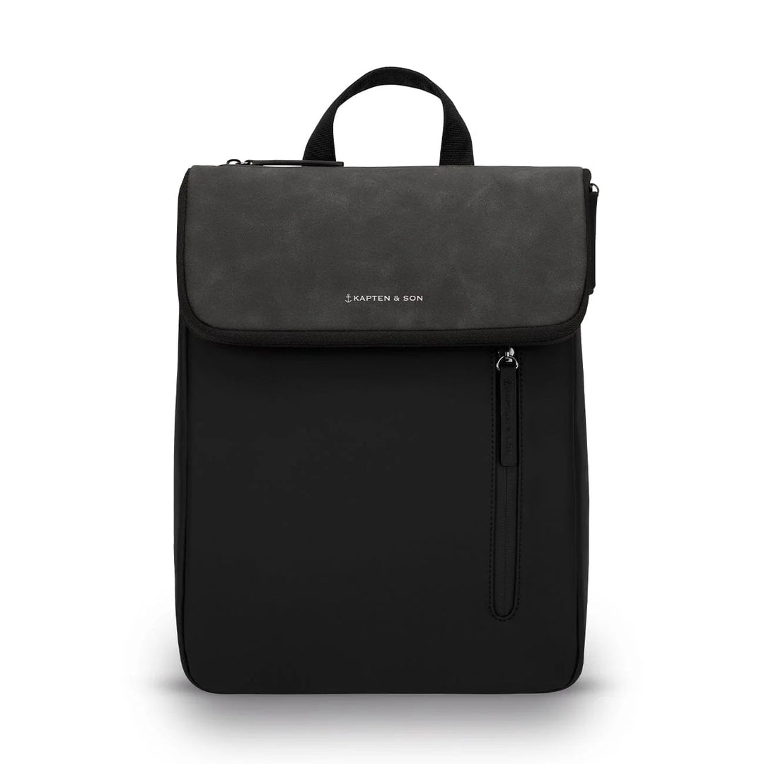 Kapten & Son Vallen Backpack in black — slim vegan leather mini backpack with suede flap and vertical zip pocket