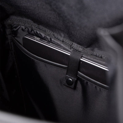 Interior padded laptop sleeve of the Sandqvist slim rolltop M in black, offering secure storage for tech on daily commutes