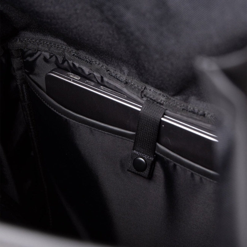 Interior padded laptop sleeve of the Sandqvist slim rolltop M in black, offering secure storage for tech on daily commutes