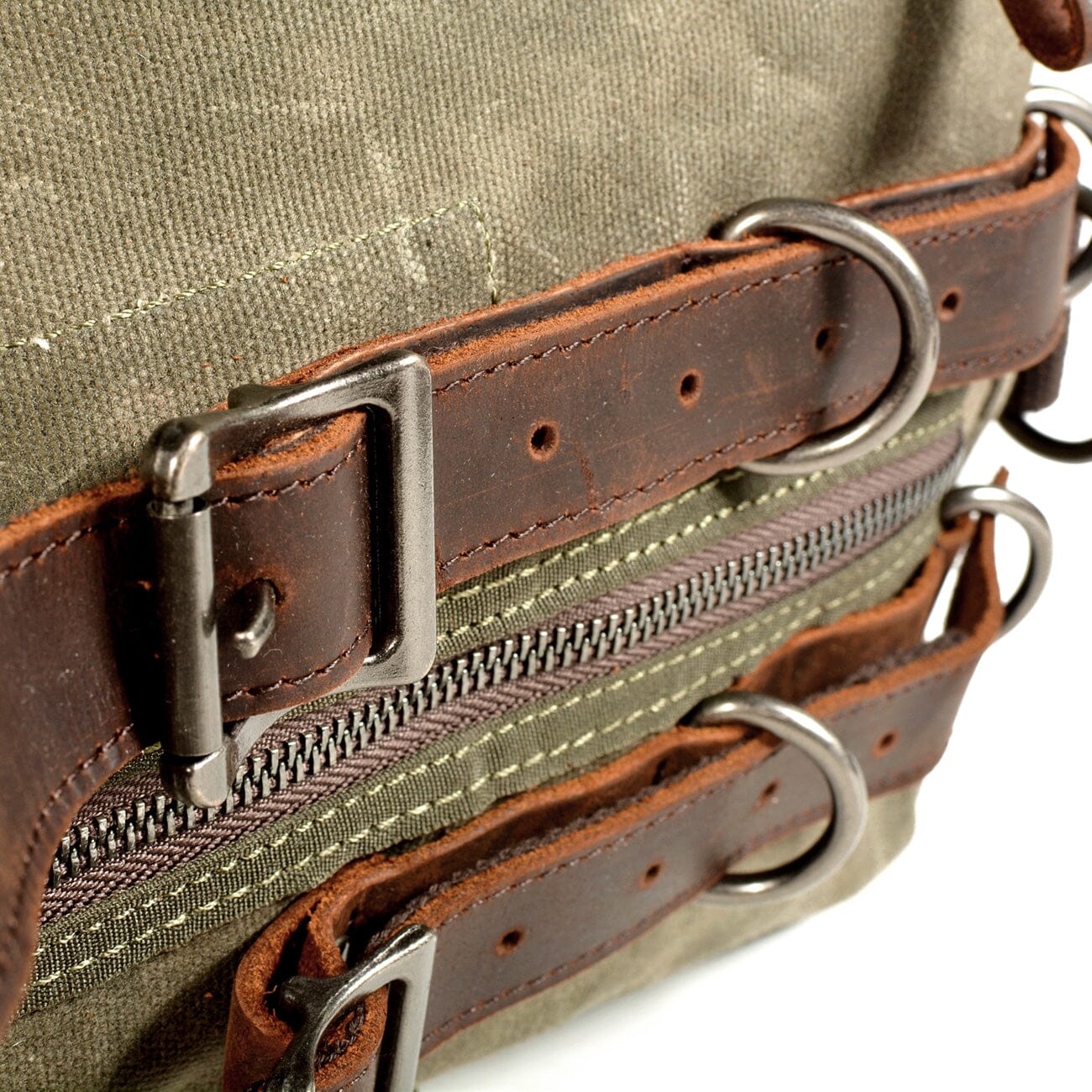 leather straps metallic buckles green waxed cotton canvas