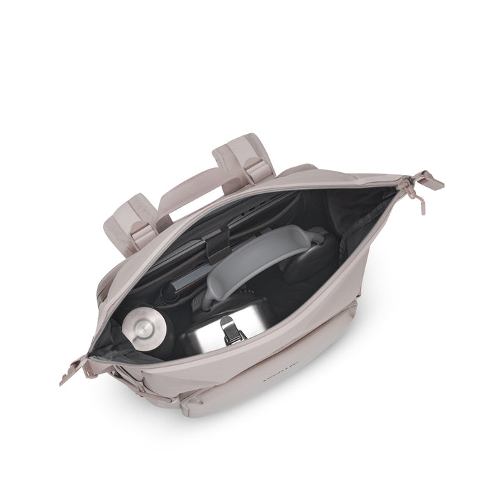 Packed with bottle, headphones, and gear — top view into rolltop