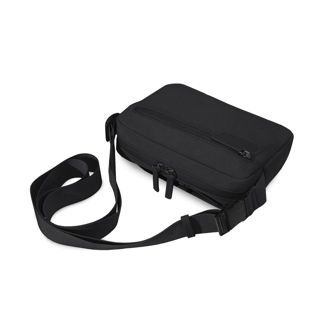 Rear view of the black Lulea with back zip pocket and full-length adjustable webbing strap laid flat