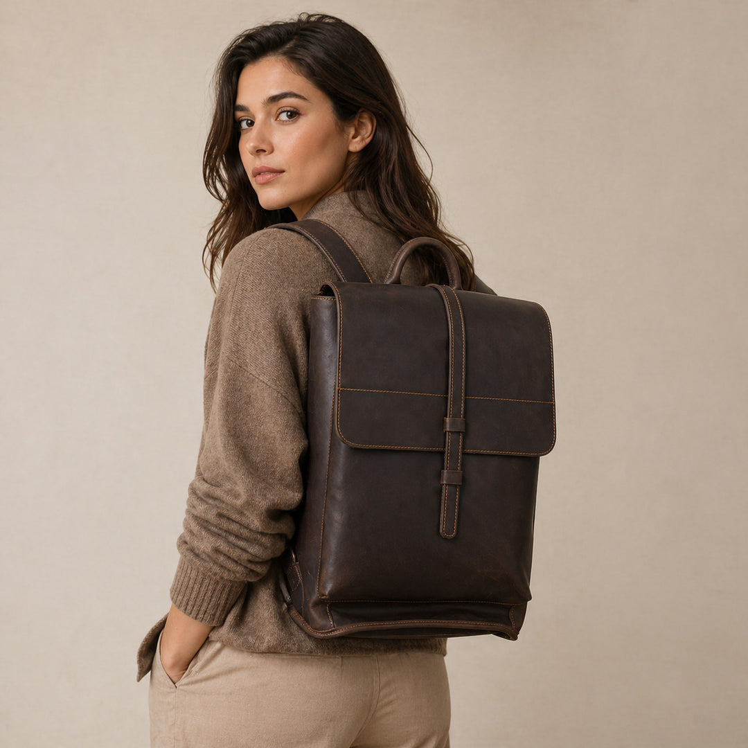 Woman wearing the Lyve leather business backpack in a studio setting