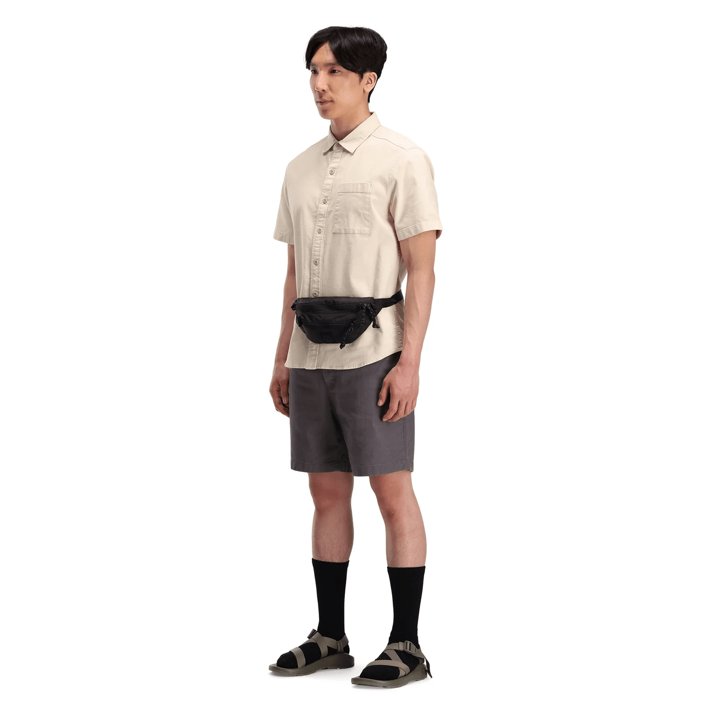 male hiker wearing black topo designs mountain waist pack as bum bag