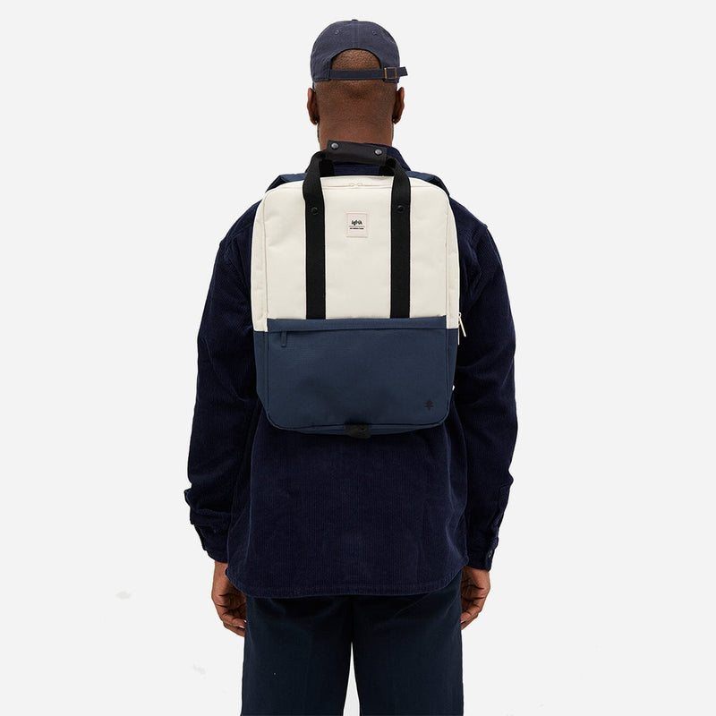 Man from the back carrying a stylish and sustainable daypack in blue and white