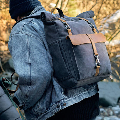 Man hiking in forest wearing a retro canvas rucksack, ideal for outdoor adventures