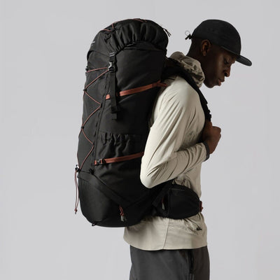 man model wearing the trail hike backpack in black in a studio setting