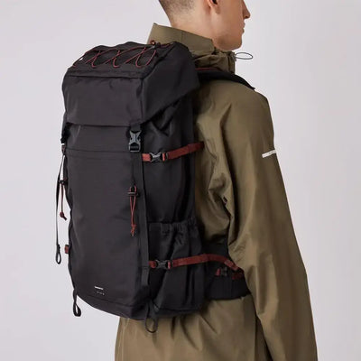 man model wearing black mountain hike pack lifestyle