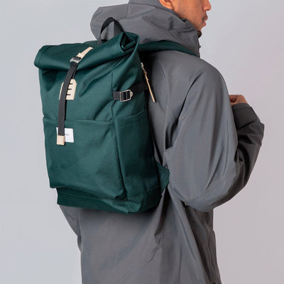 man model wearing eco friendly urban roll top backpack ilon sandqvist green