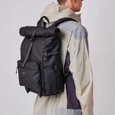 man model wearing waterproof commute backpack ruben 2 sandqvist black color