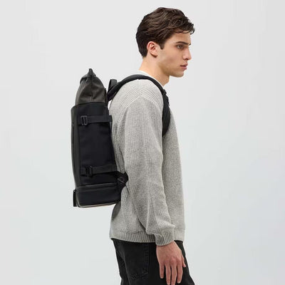 man wearing all black helsinki backpack kapten son model lifestyle