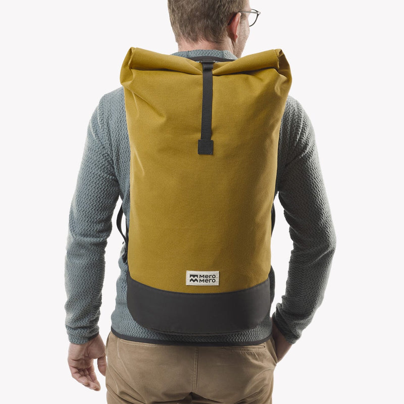 man wearing chai tea roll top squamish backpack mero mero back view