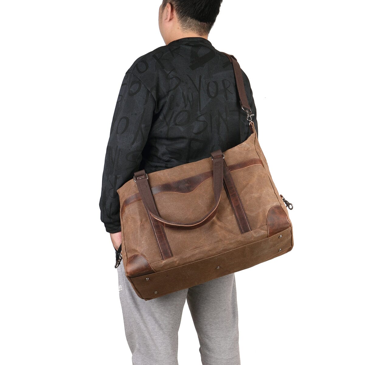 man wearing coffee canvas leather duffle bag