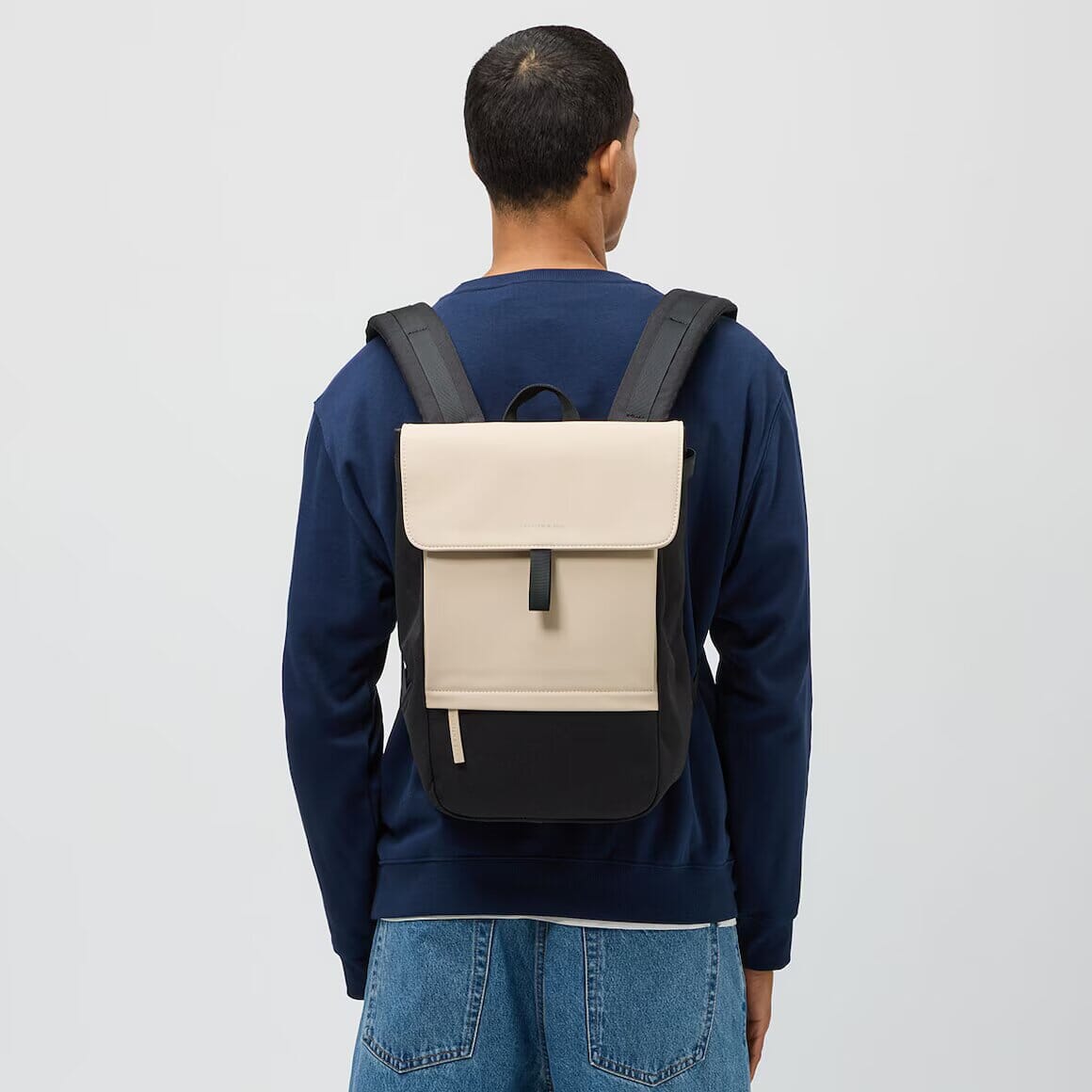 man wearing cream black fyn backpack kapten son back