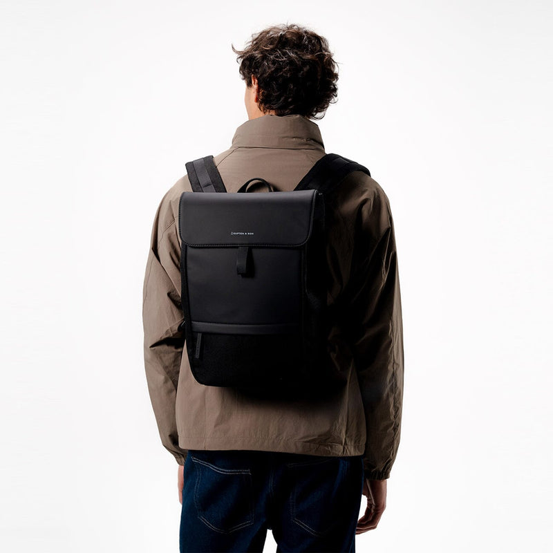 man wearing kapten son fyn backpack black, back view