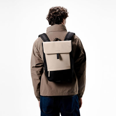 man wearing kapten son fyn backpack cream black, back view