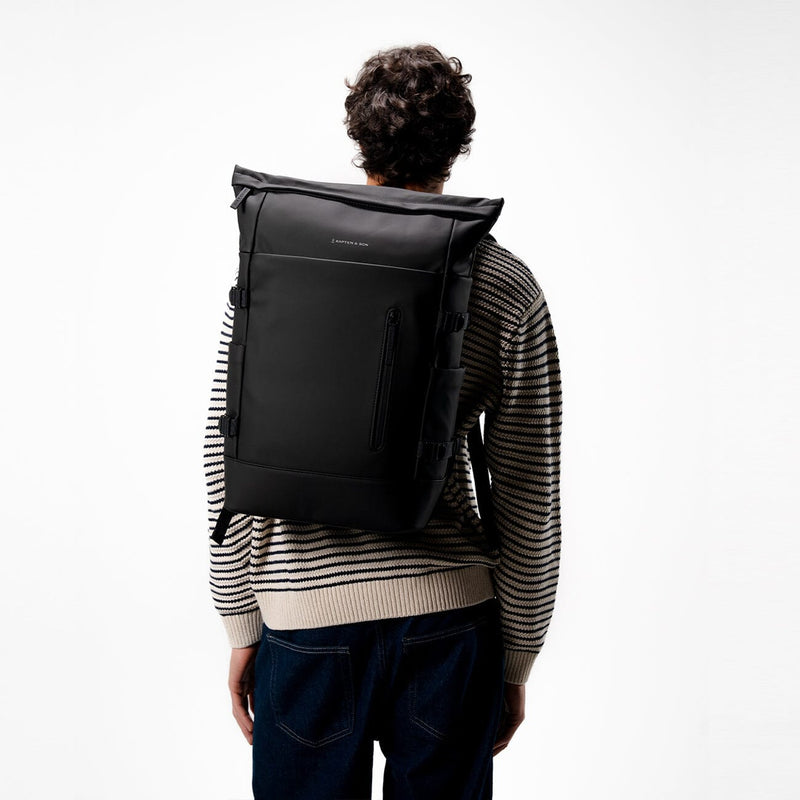 man wearing kapten and son helsinki pro backpack all black, back view