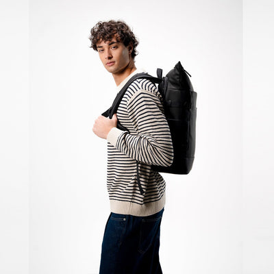 man wearing kapten and son helsinki pro backpack all black, side view