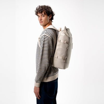 man wearing kapten and son helsinki pro backpack sandstone, side view