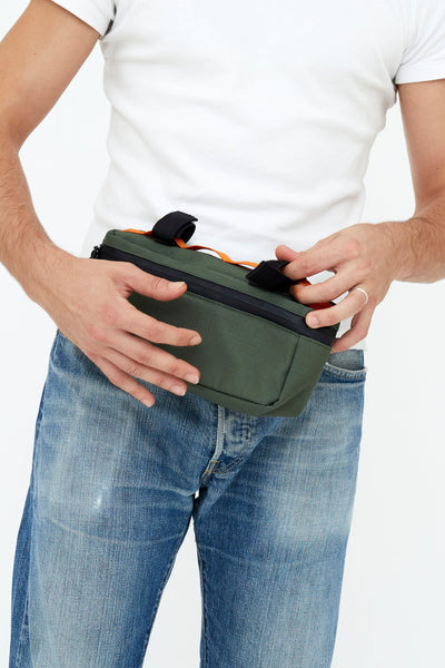 man wearing lefrik core sustainable chest bag pine color as fanny pack