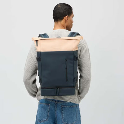 man wearing navy blush helsinki backpack kapten son model lifestyle.jpg