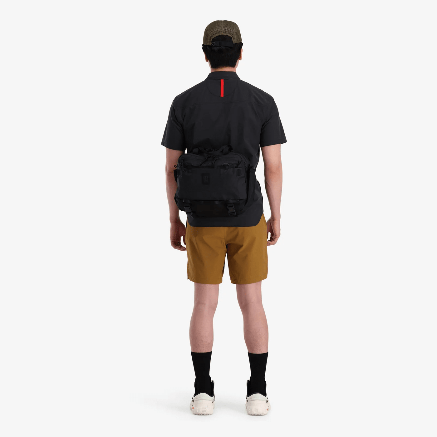 man wearing topo designs mountain cross bag 17L as cross body bag