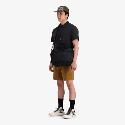 man wearing topo designs mountain cross bag 17L as sling bag