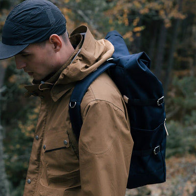 man in the wilderness wearing the ilon sandqvist backpack in navy blue