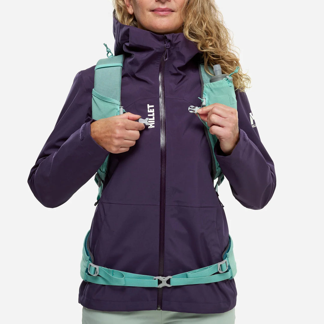 Sternum strap magnetic buckle detail while worn by woman hiker