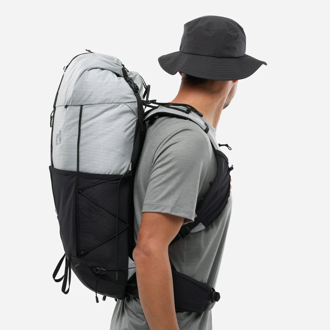 Lifestyle shot — man wearing Parmelan 25L Silverstone, side profile with bucket hat