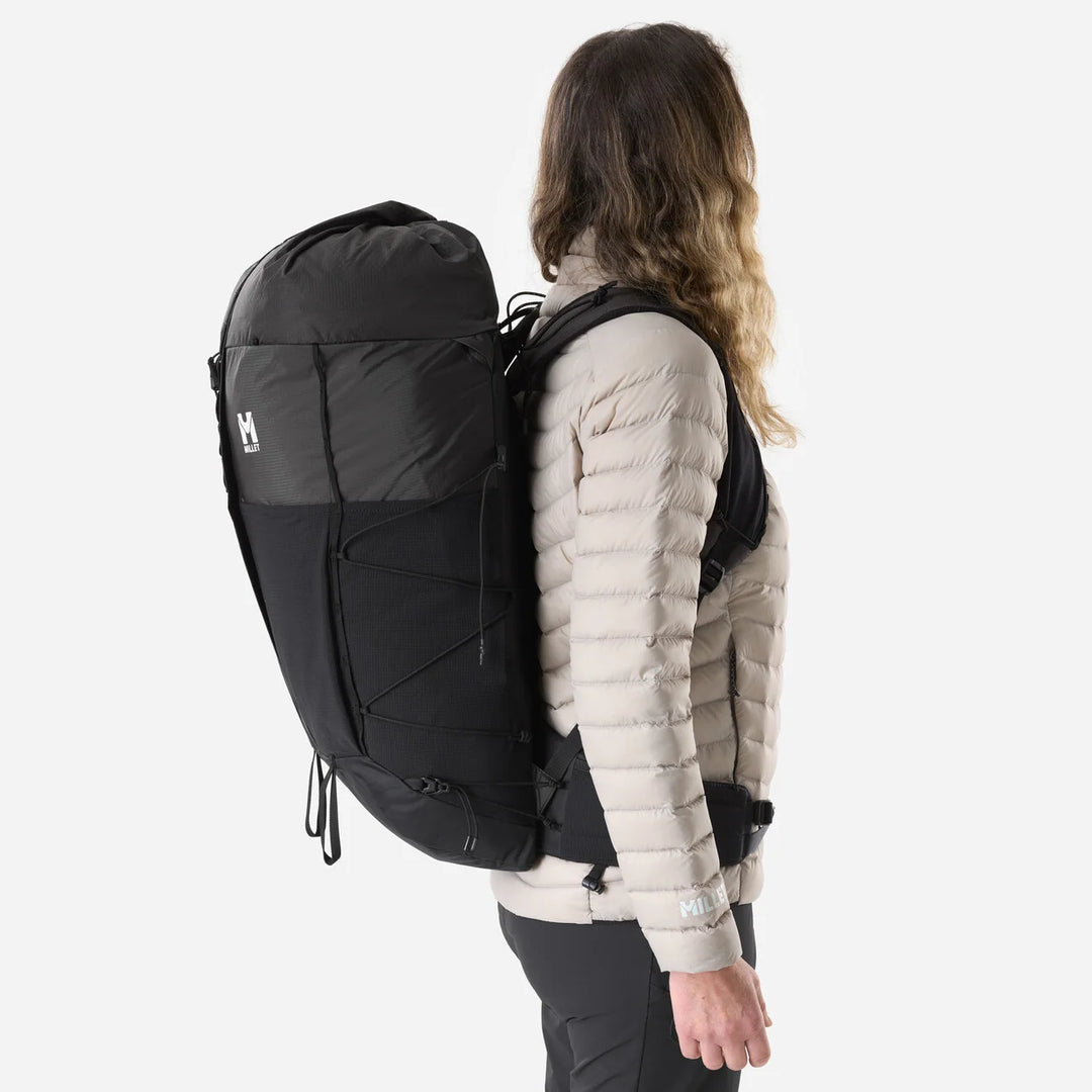 Lifestyle shot — woman wearing Parmelan 35L Black, side profile showing volume and fit