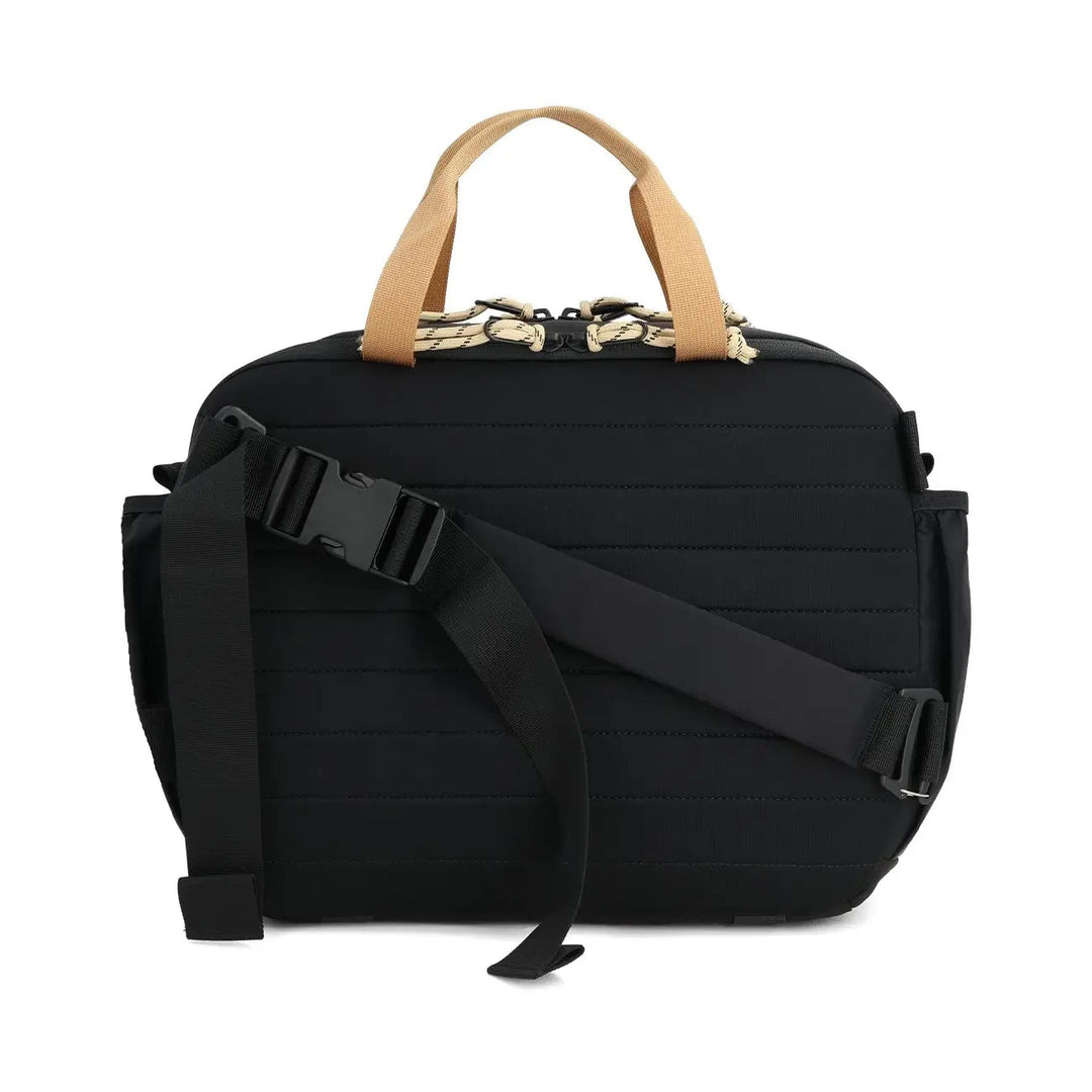 Rear view of the Mountain Cross Bag 17L in black and neutral with padded back panel and adjustable strap