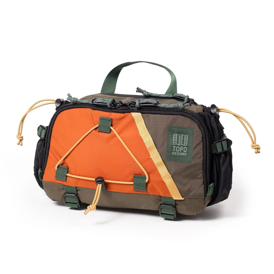 Side view of the Mountain Hydro Hip Pack in woodland and terracotta with elastic water bottle pocket