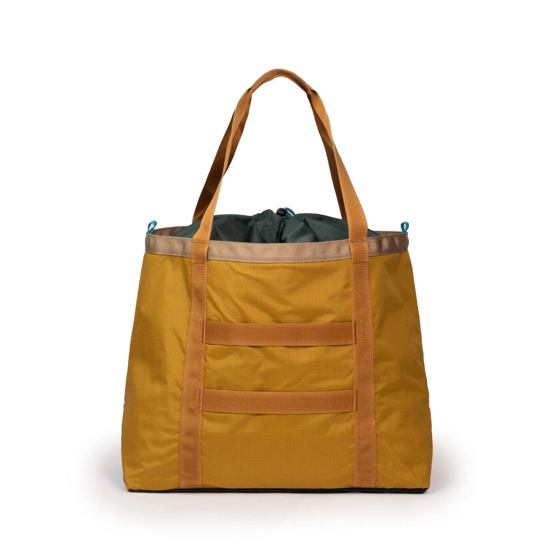 Rear view of the Mountain Utility Tote 33L in mustard and forest