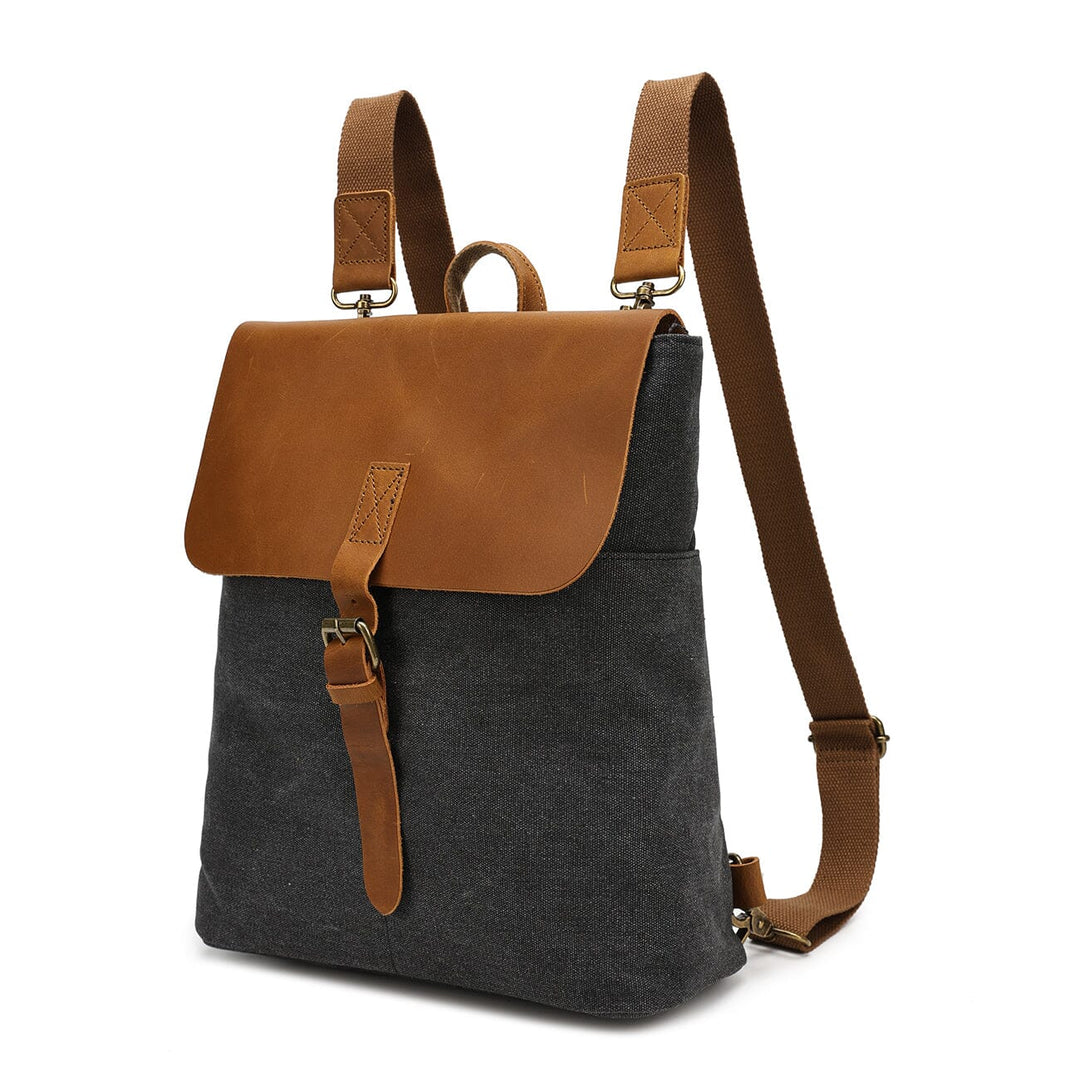 Side view of the dark grey Nora canvas backpack showing the slim profile and adjustable leather strap