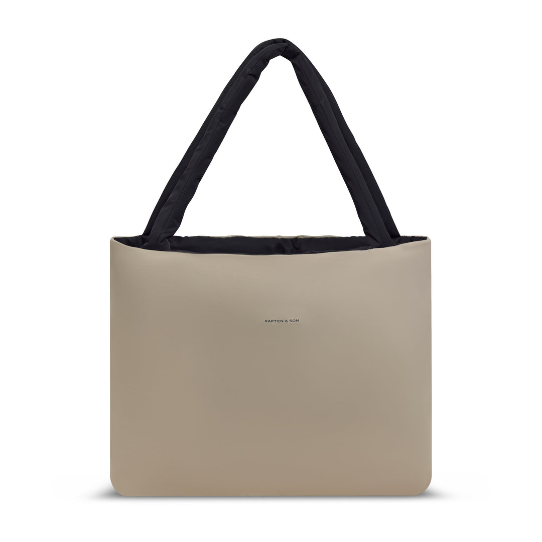 Same tote reversed to the sand side — front view with the tonal logo and padded shoulder handles