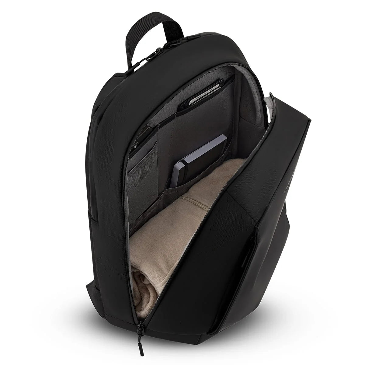 Wide-opening main compartment packed with a sweater and a notebook in the organiser