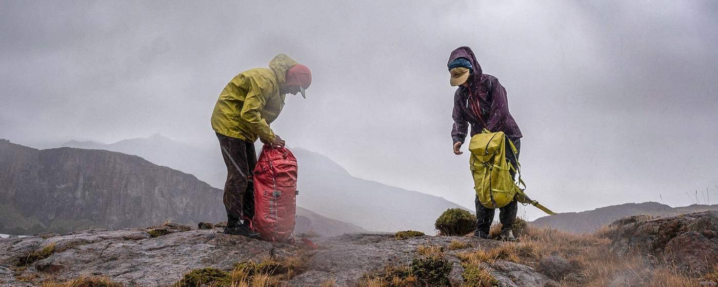 two hiker wearing waterproof patagonia backpacks during a rainy Norway hike