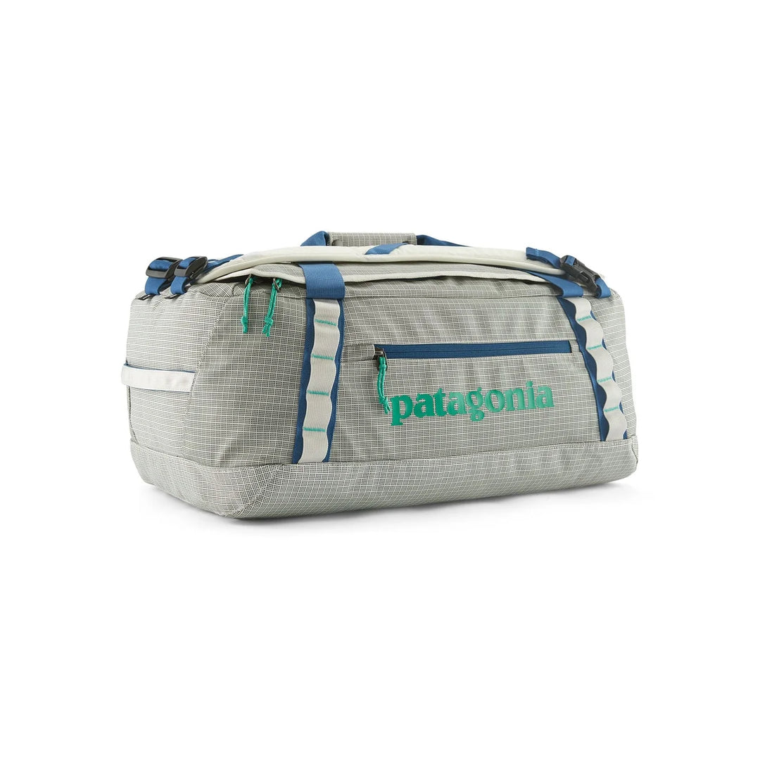 Patagonia Black Hole Duffel 40L Birch White — side view in duffel mode with green Patagonia logo