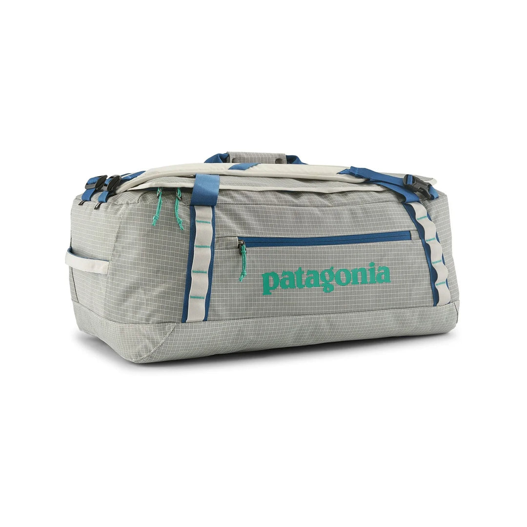 Patagonia Black Hole Duffel 55L Birch White — side view in duffel mode with green Patagonia logo