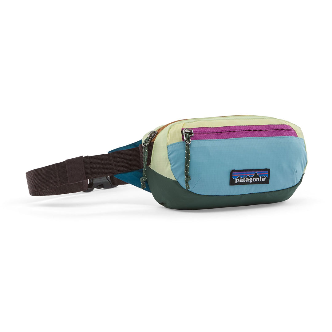 Patagonia Terravia Mini Hip Pack in Patchwork Snowmelt Blue — front view with colour-block panels and pink zip