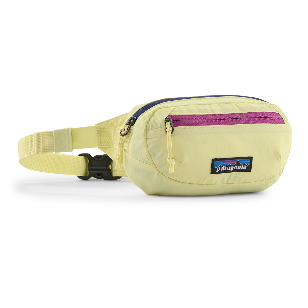 Patagonia Terravia Mini Hip Pack in Vellum Green — front view with pink zip and pale yellow body